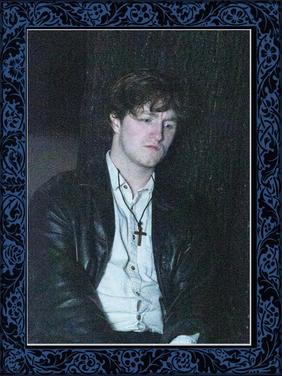 A flash-lit portrait surrounded by a patterned blue border.